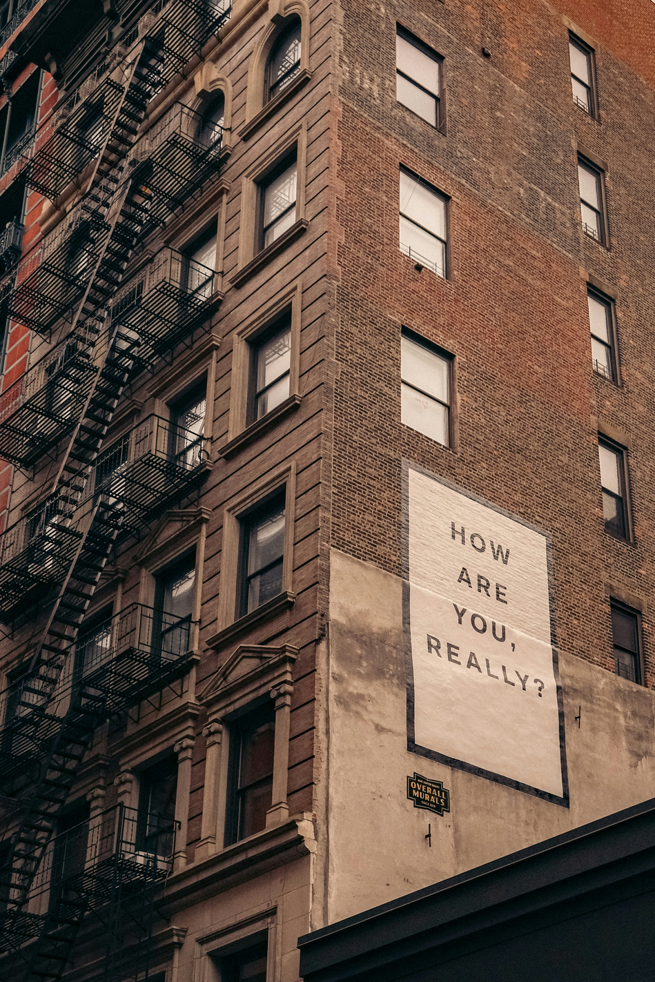 A building with a sign that says "How are you, really"?